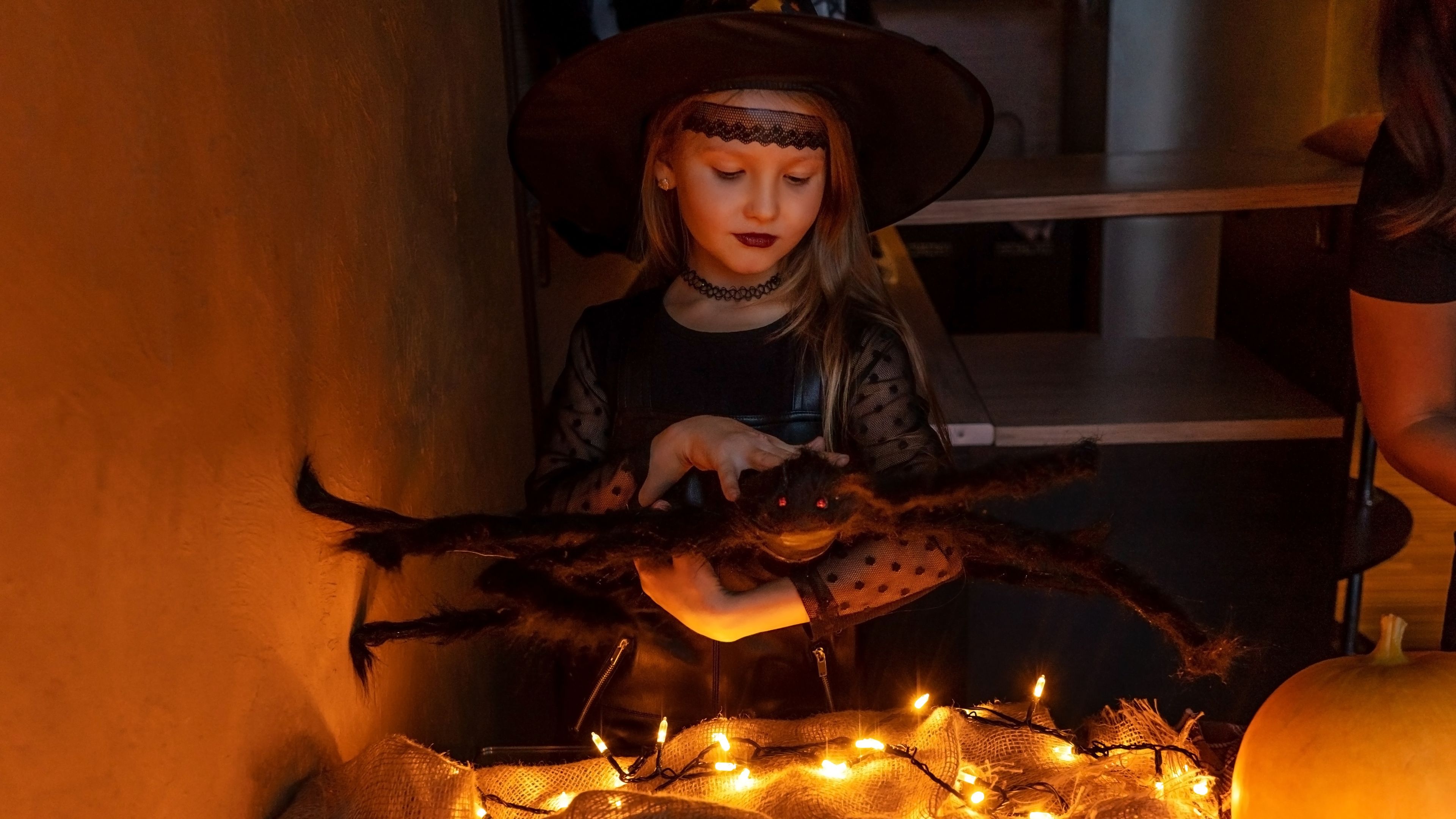 Child preparing for Halloween in a witch costume