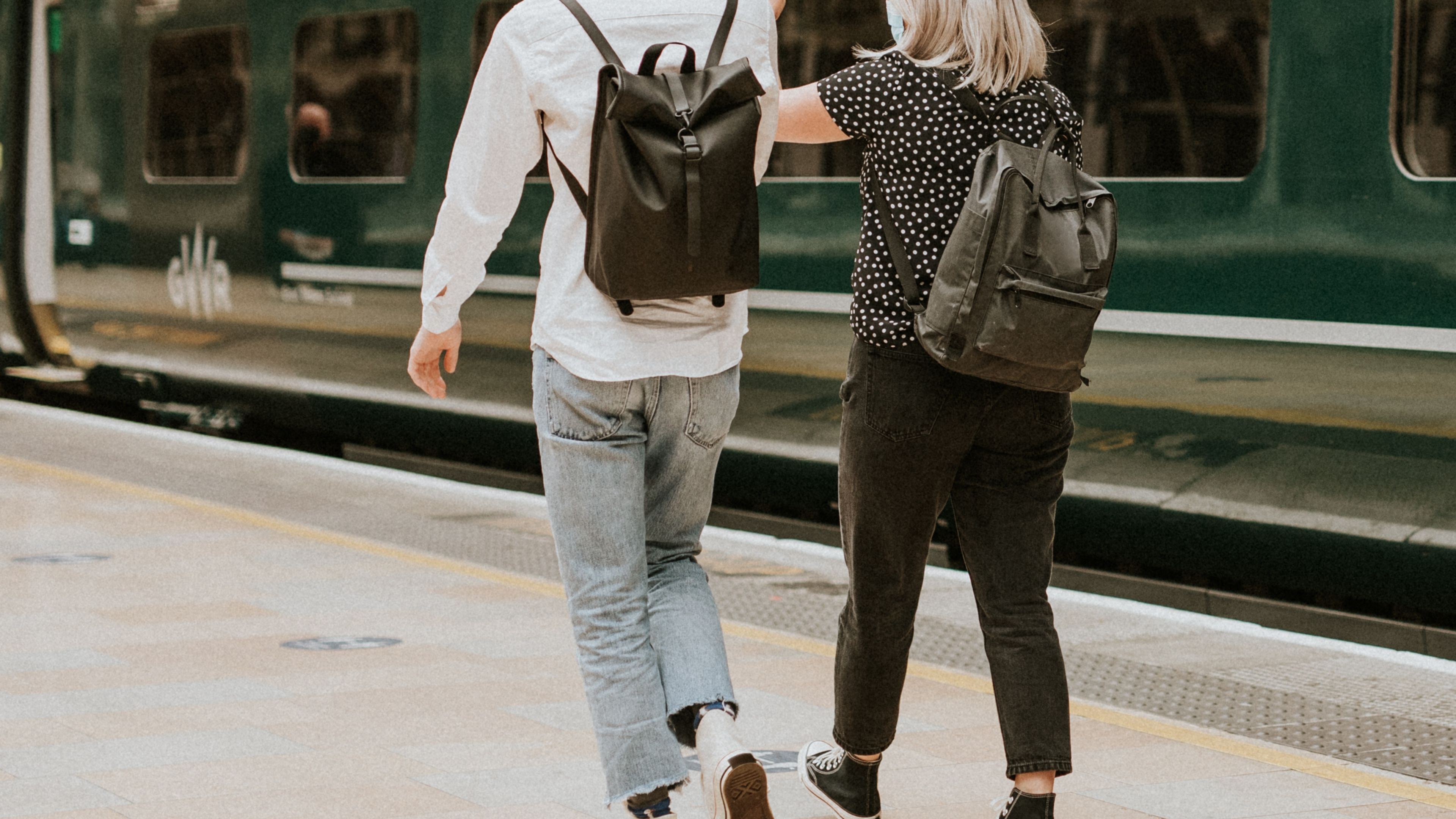 Colleagues travelling together on a train platform 