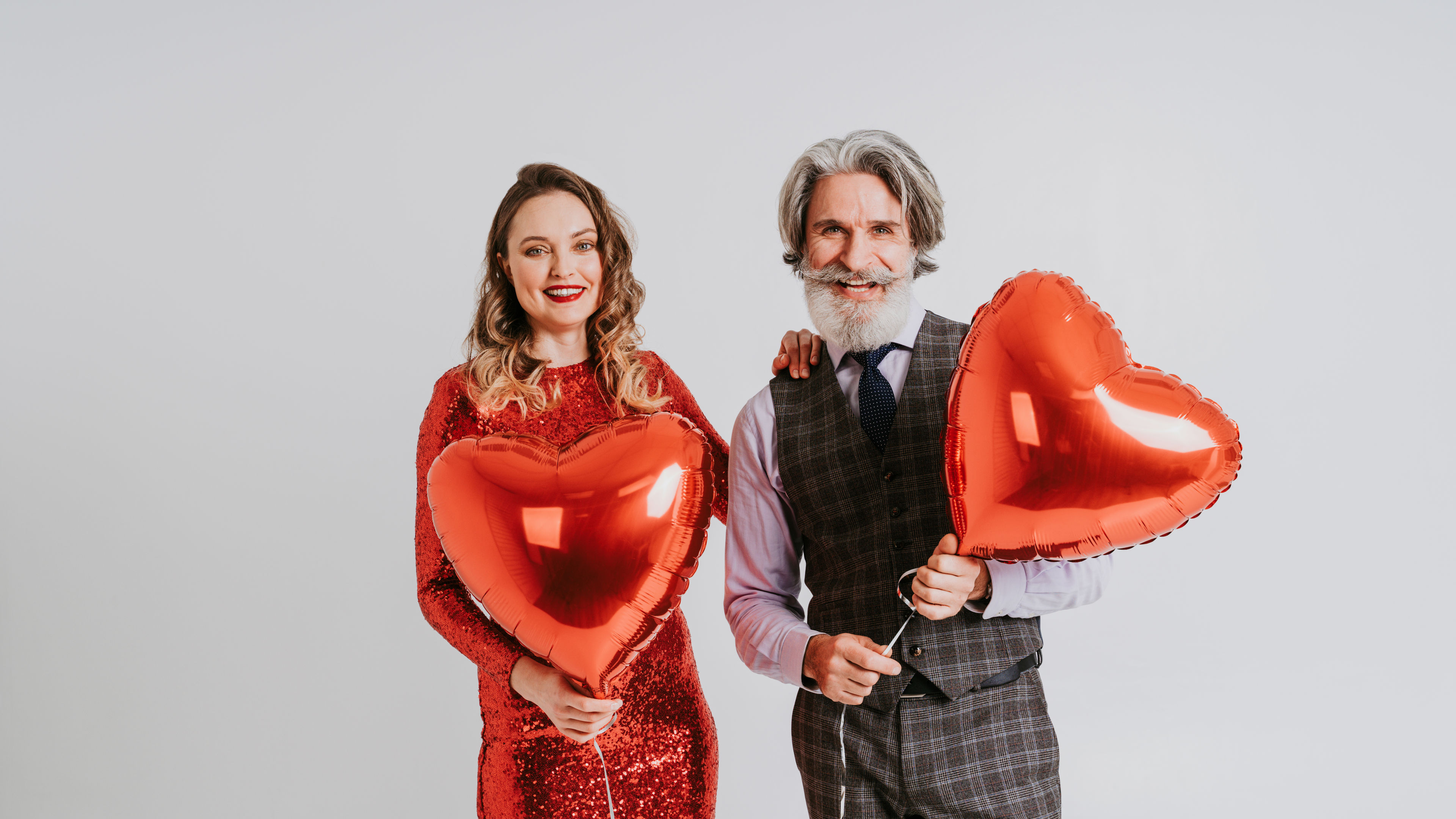 A couple in love joyfully celebrating Valentine's Day together. 

