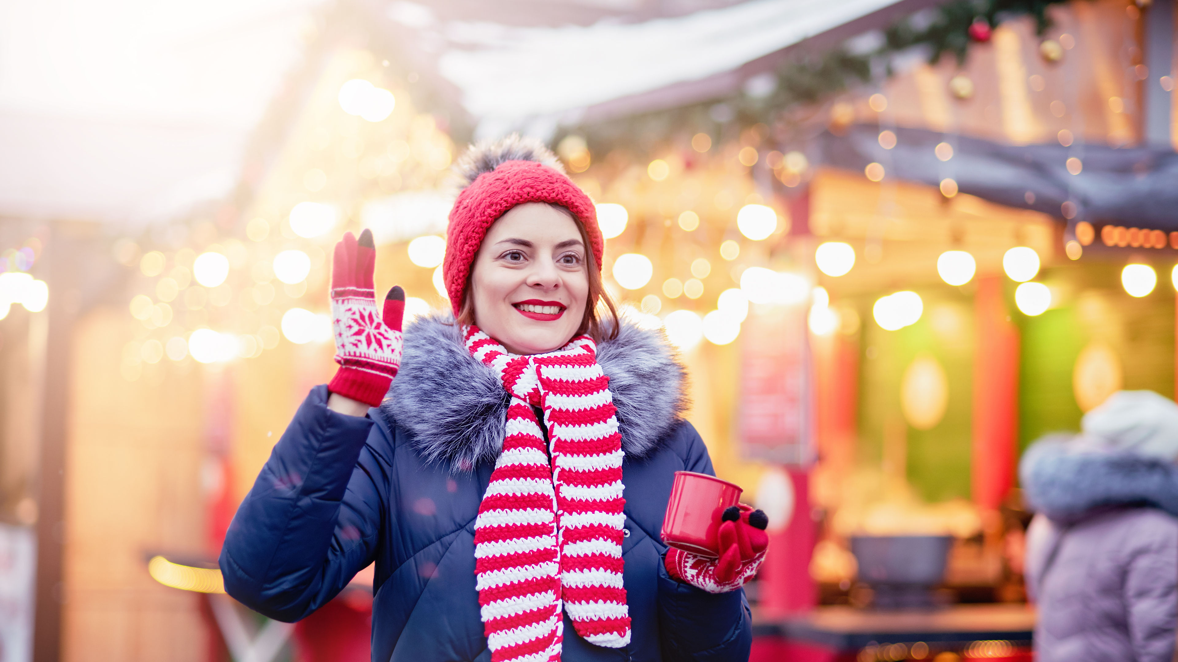 Woman drinking punch at a Christmas market. 
