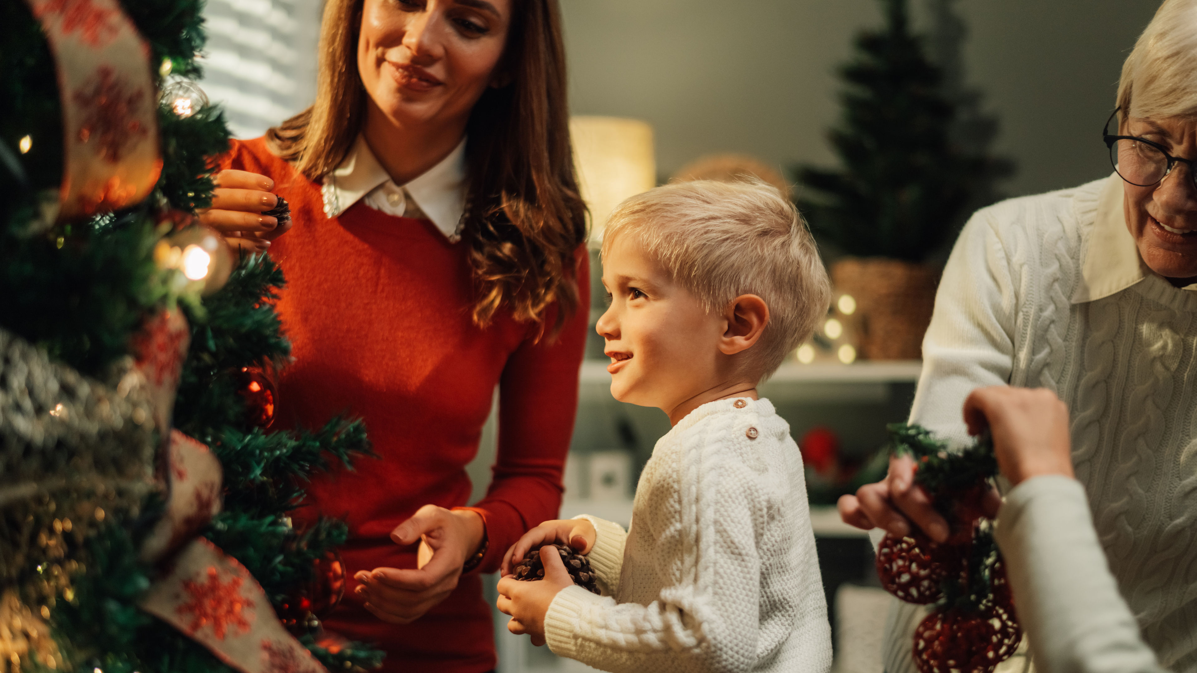Image of a family Family decorating tree at home for xmas 