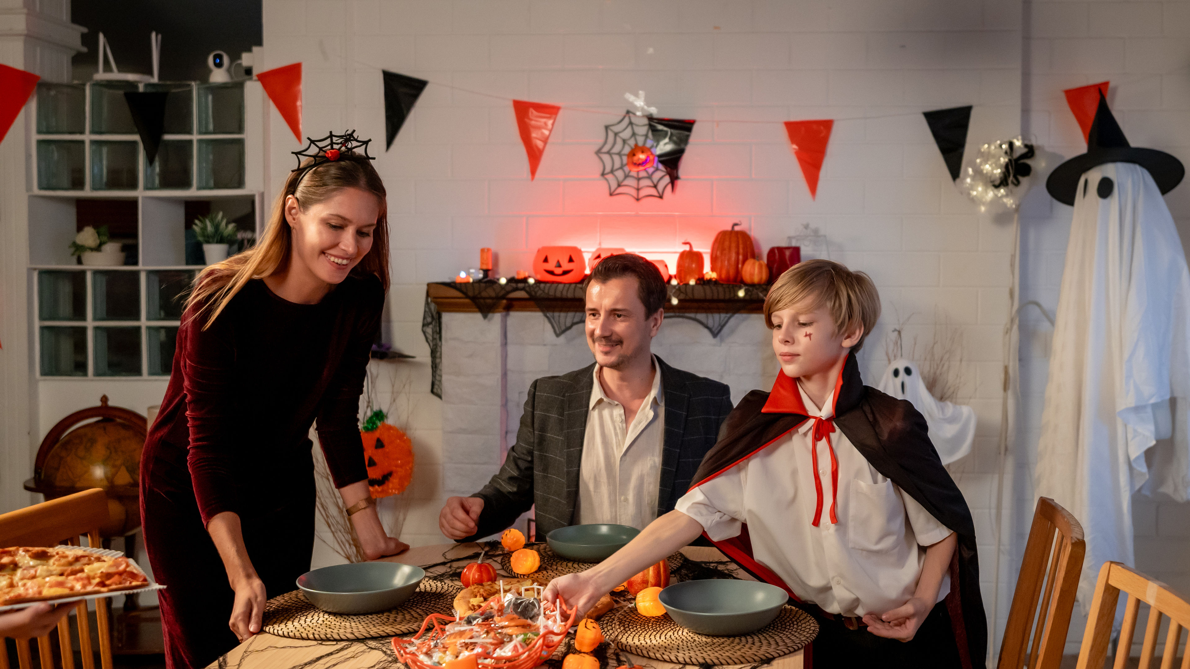 A loving family joyfully celebrating Halloween together, creating cherished memories with decorations, costumes, and festive activities. 