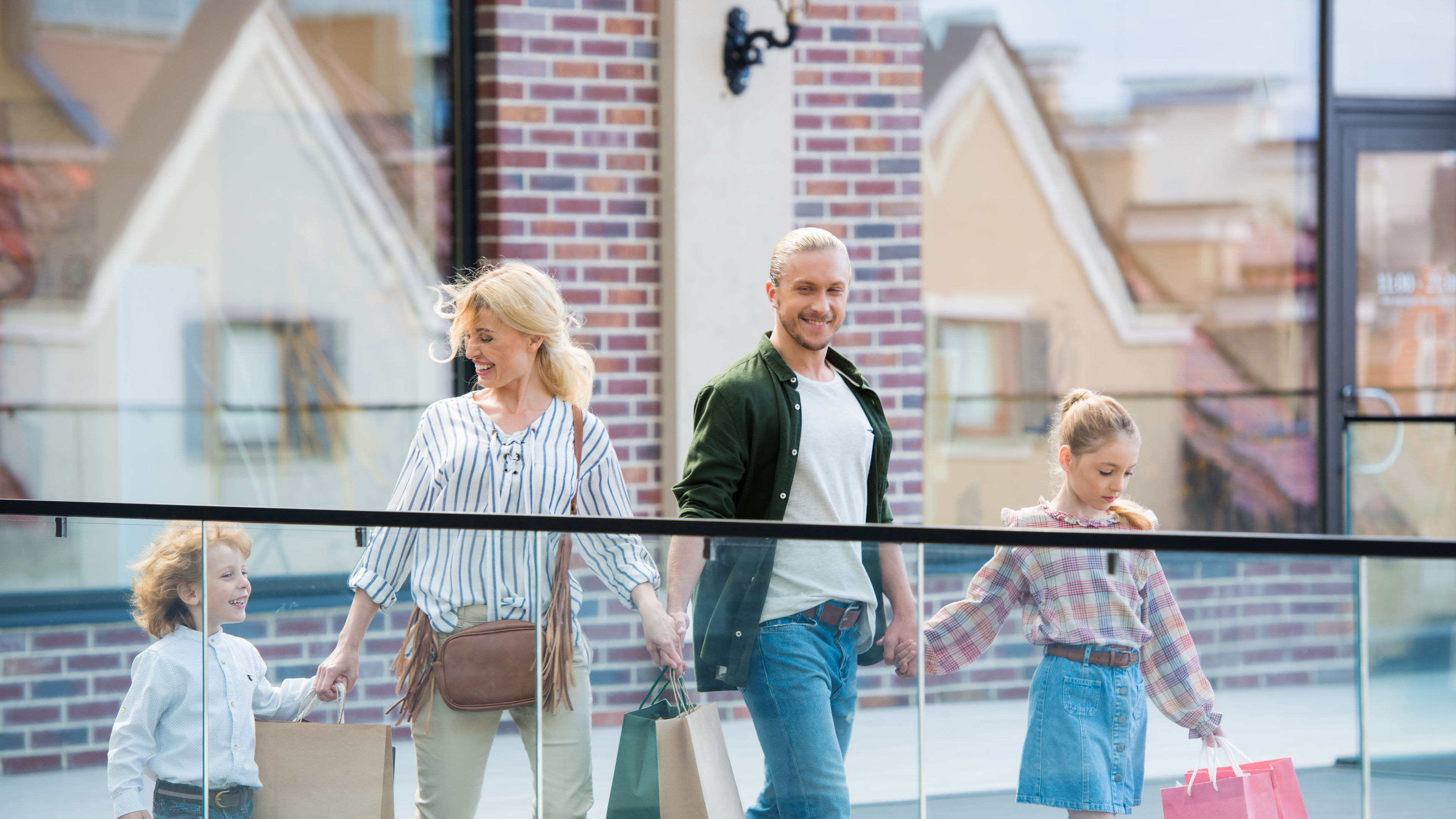 Image of a Family walking together after shopping in the stores 
