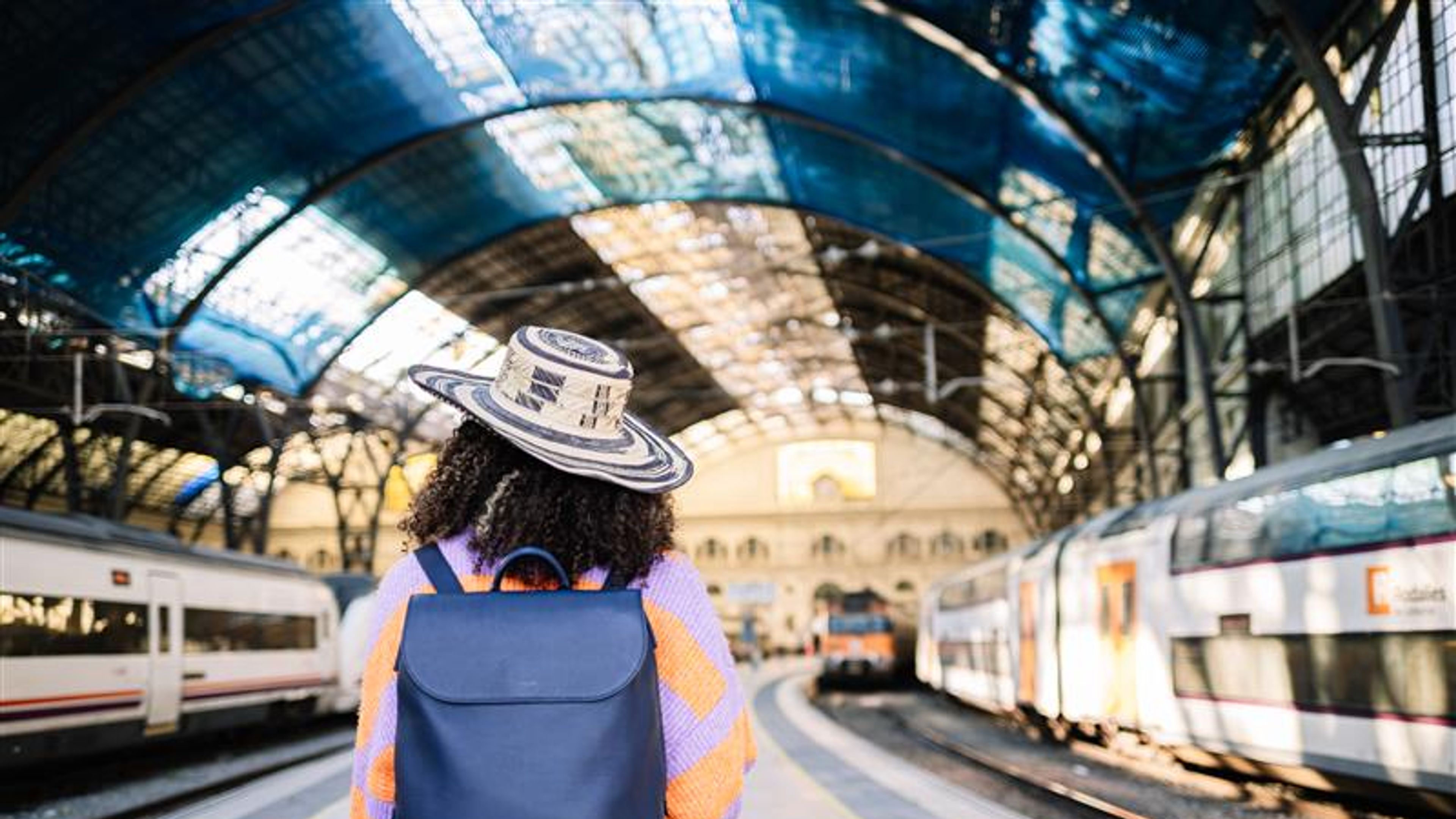 Female traveler waiting for train on platform 