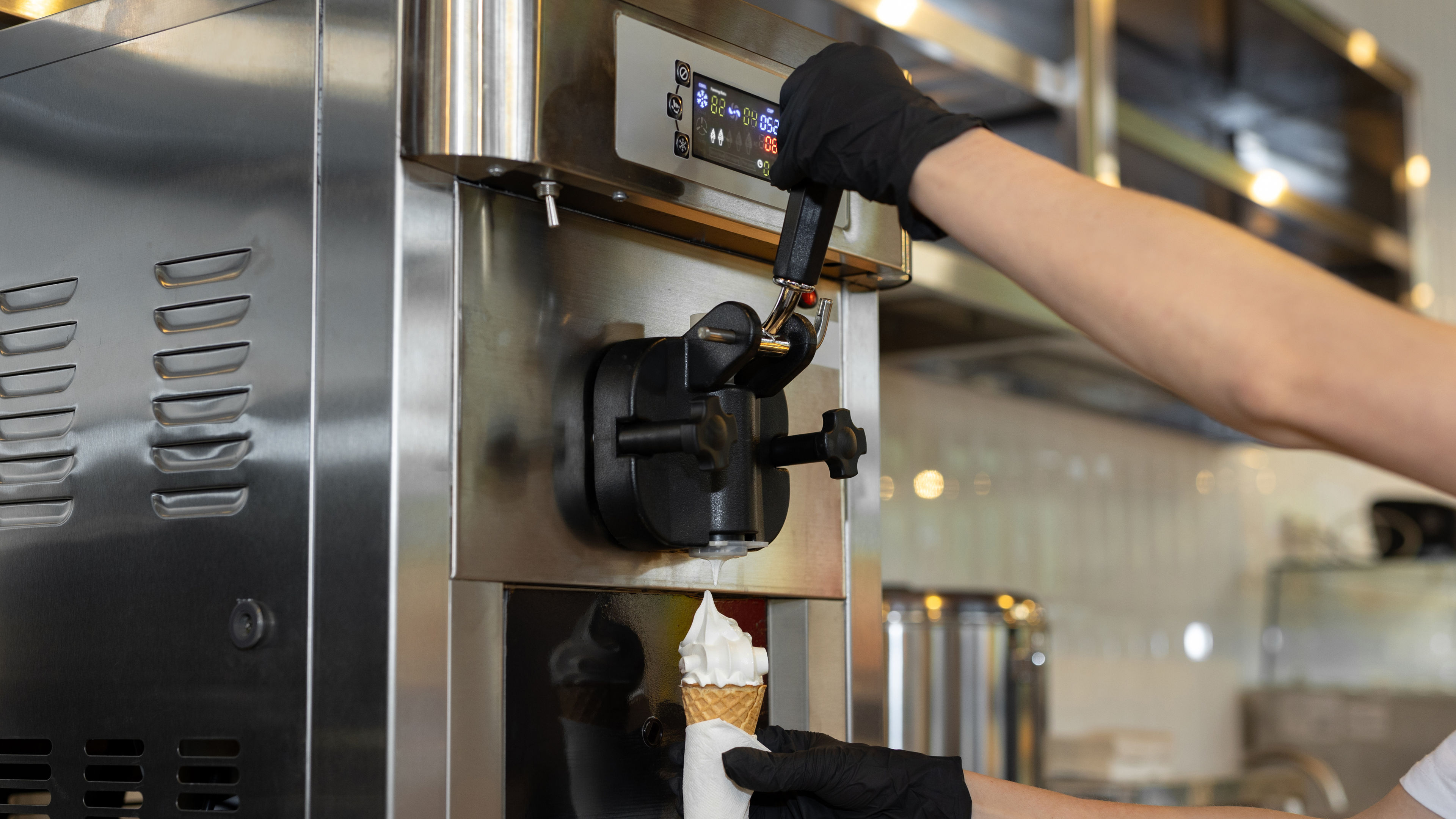 Gloved Hands Filling a Waffle Cone
