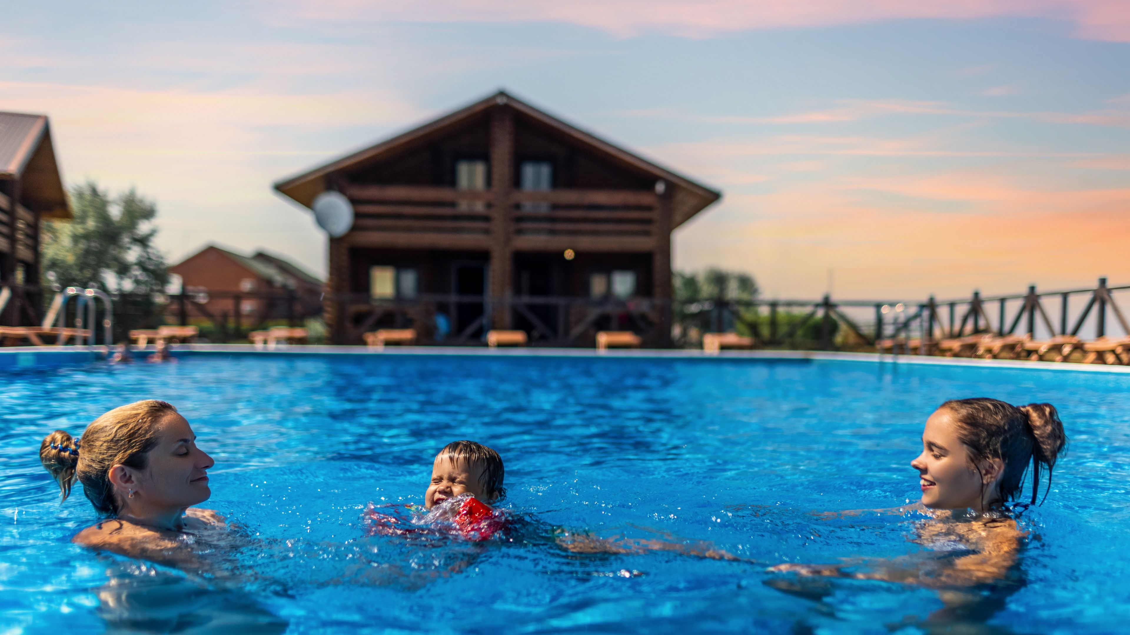 Happy beautiful cheerful mom plays with her children