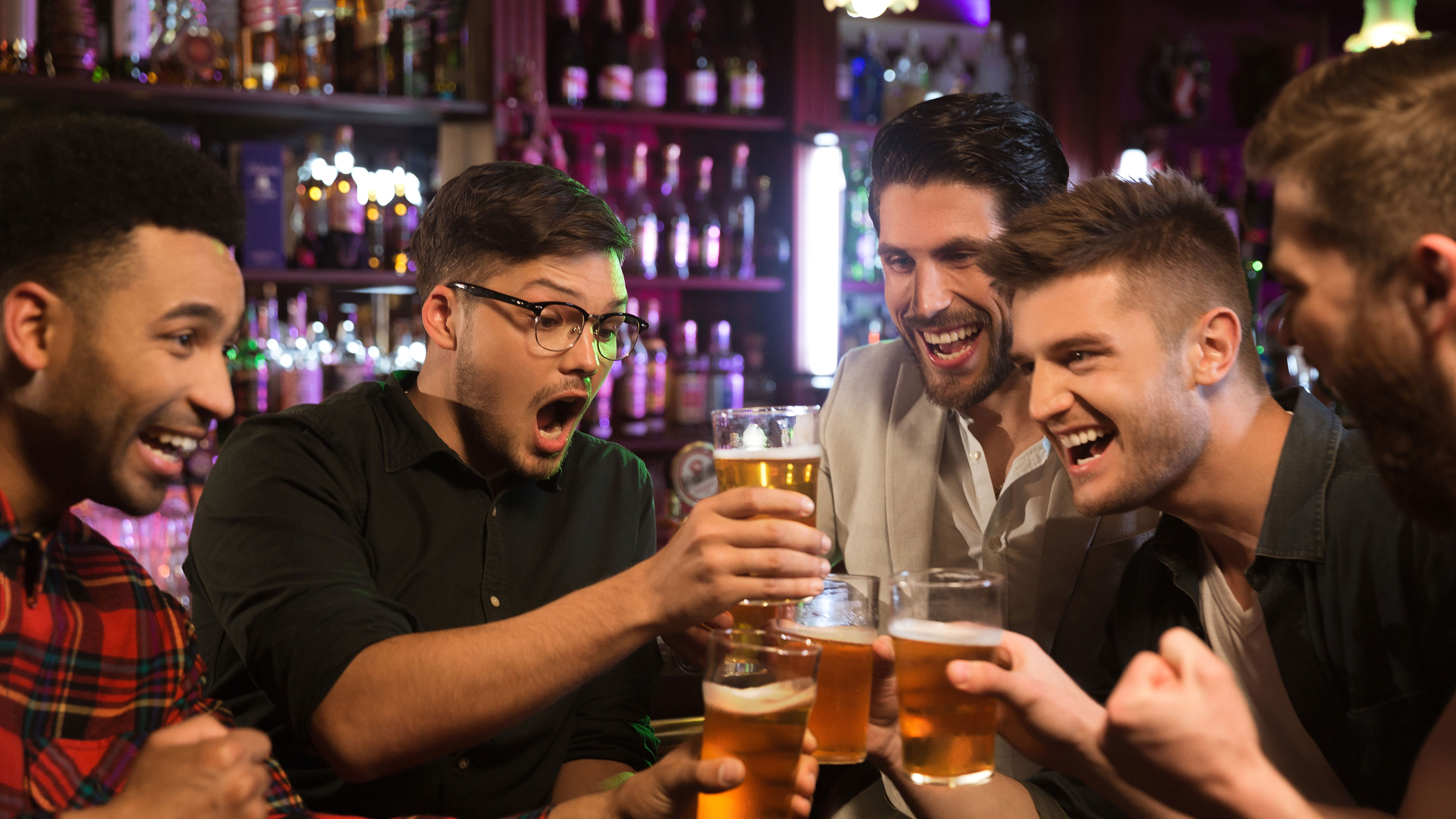 Male Friends Clinking With Beer Mugs