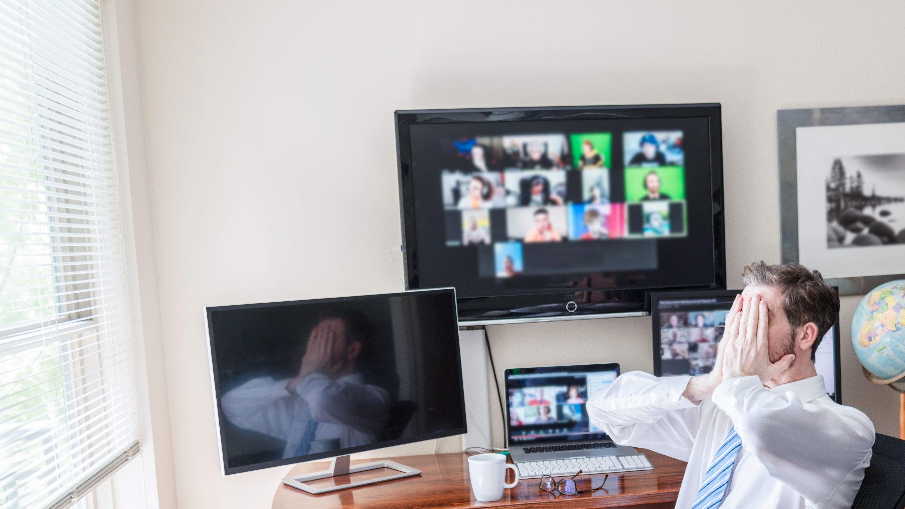 A man actively collaborating with his team through a video chat session, appearing engaged and focused as they discuss ideas, share insights, and work on a project together. 