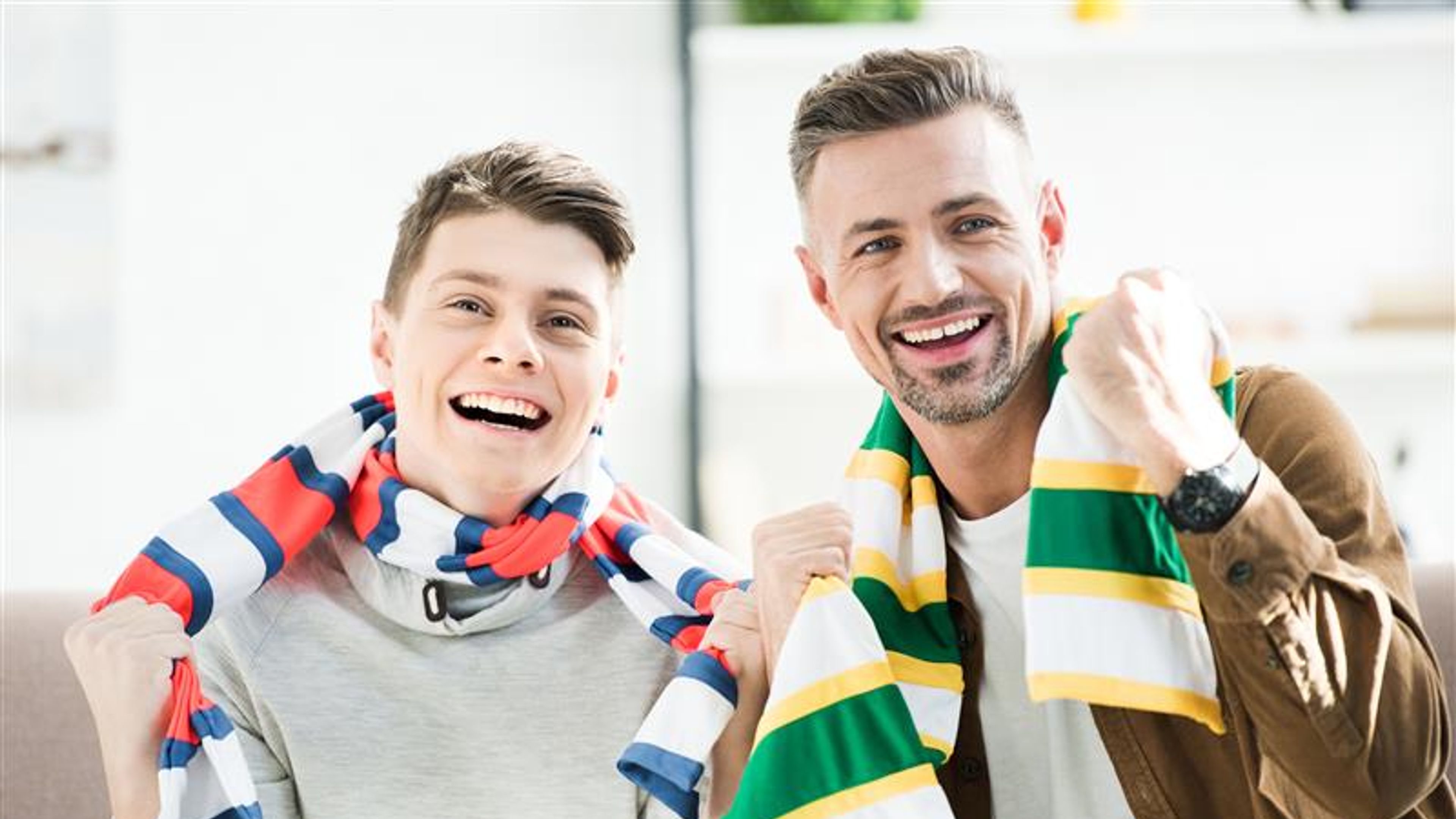 Portrait of smiling father and teen son in scarfs