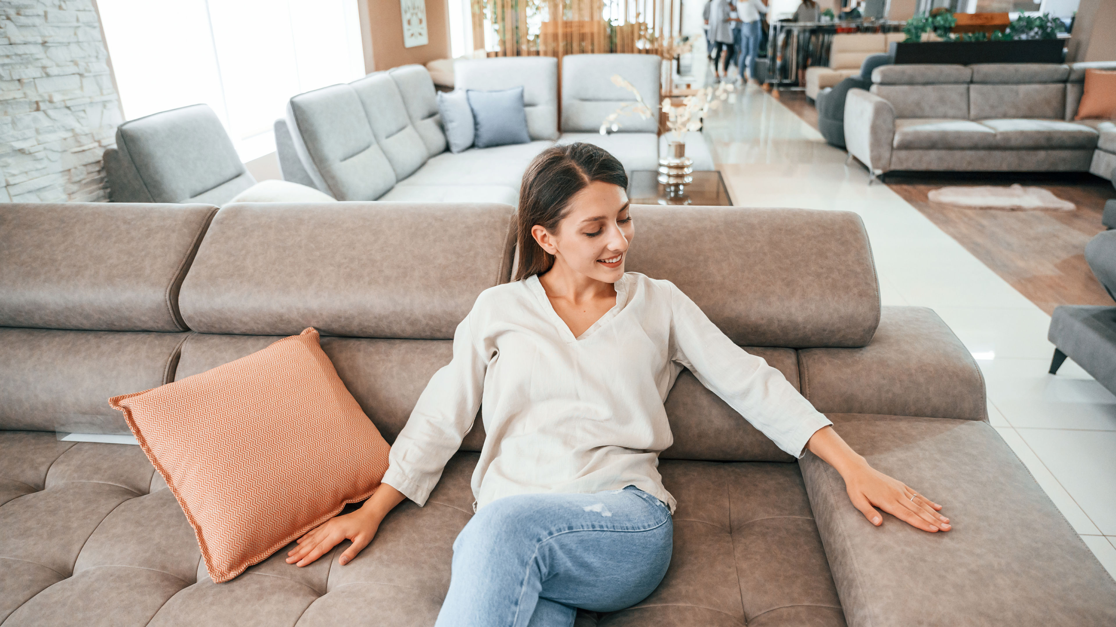 Smiling Woman Relaxing on a Sofa 