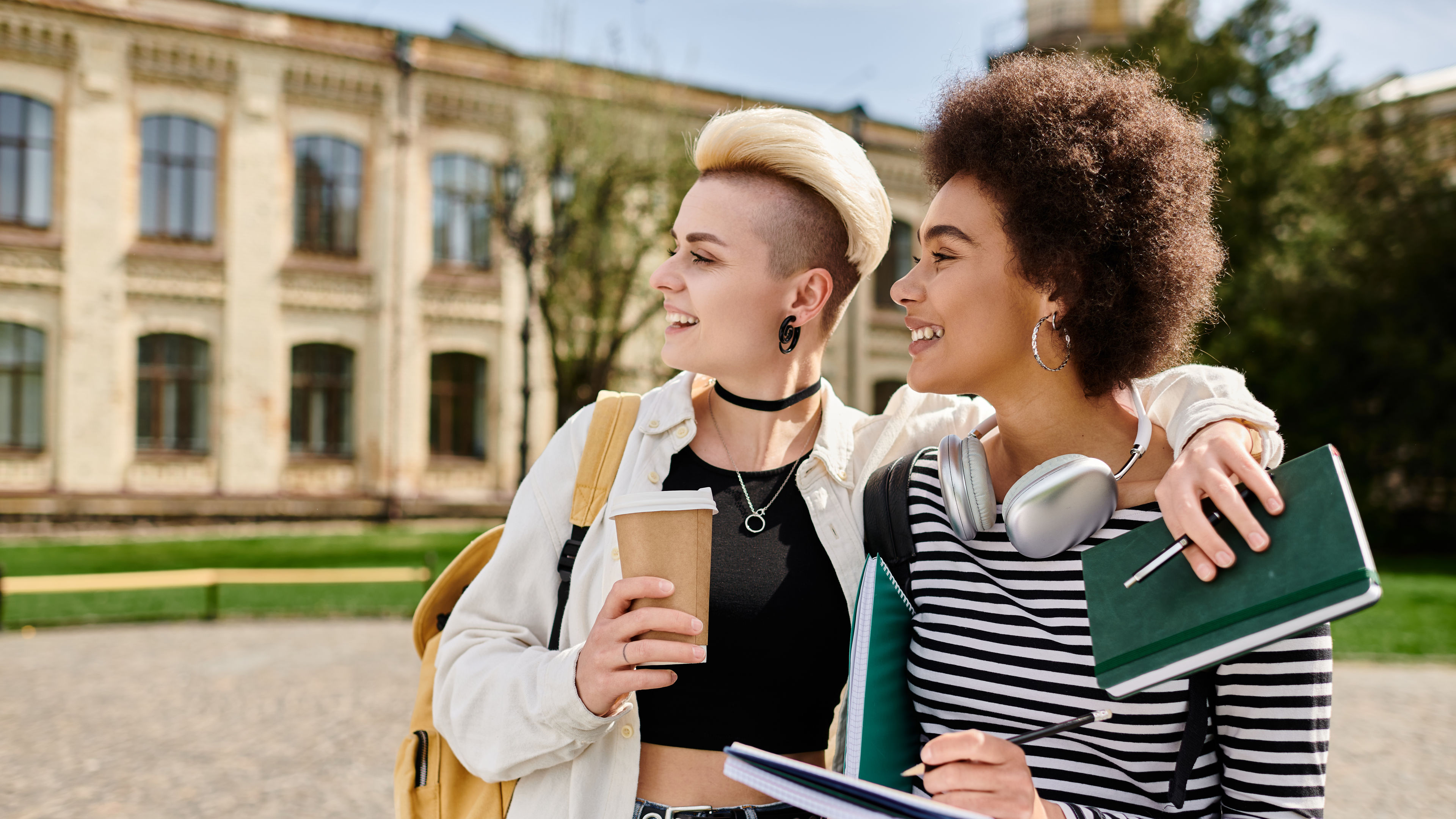 Urban elegance: two young women standing before historic building 