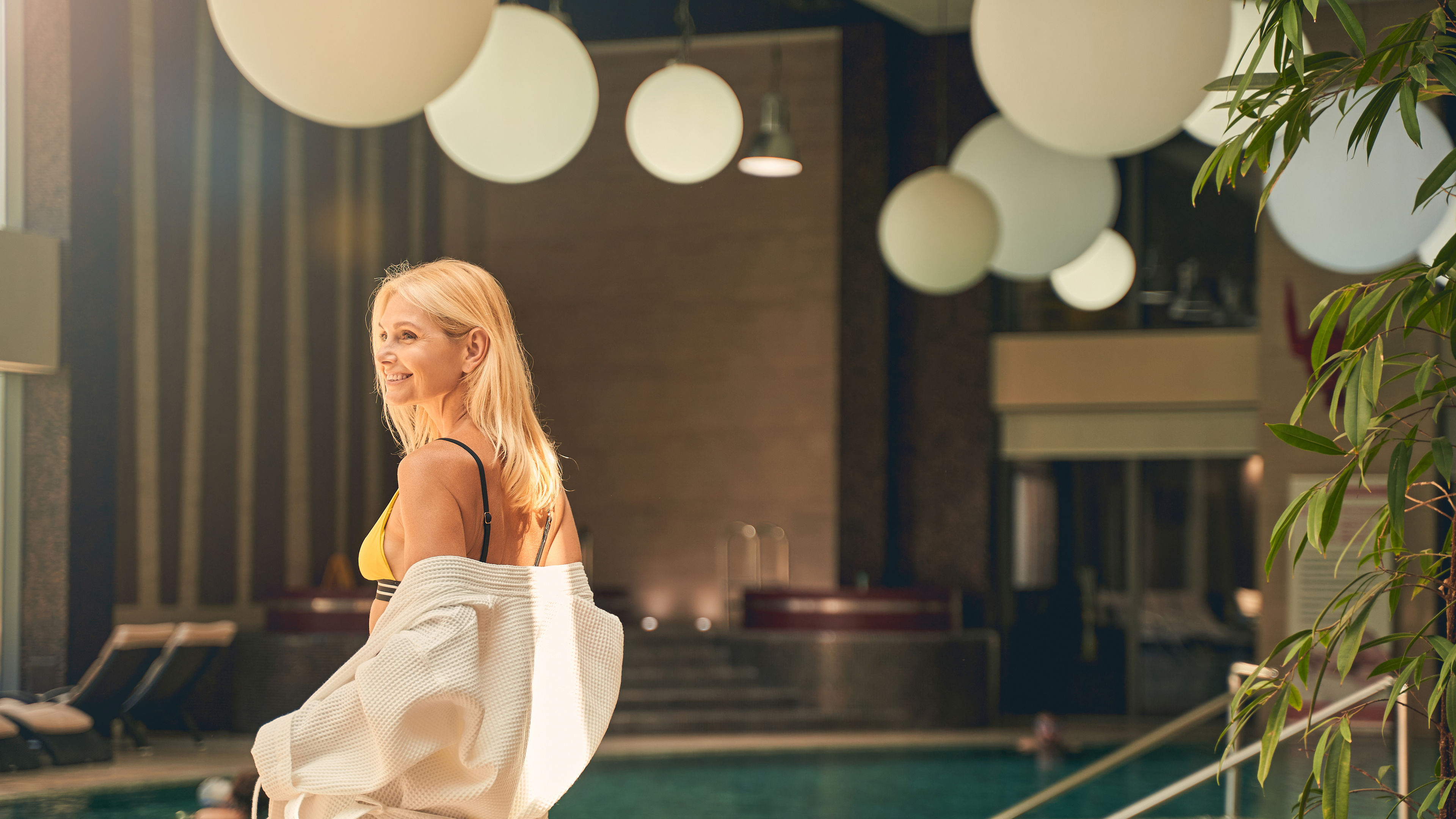 Woman standing near the pool 