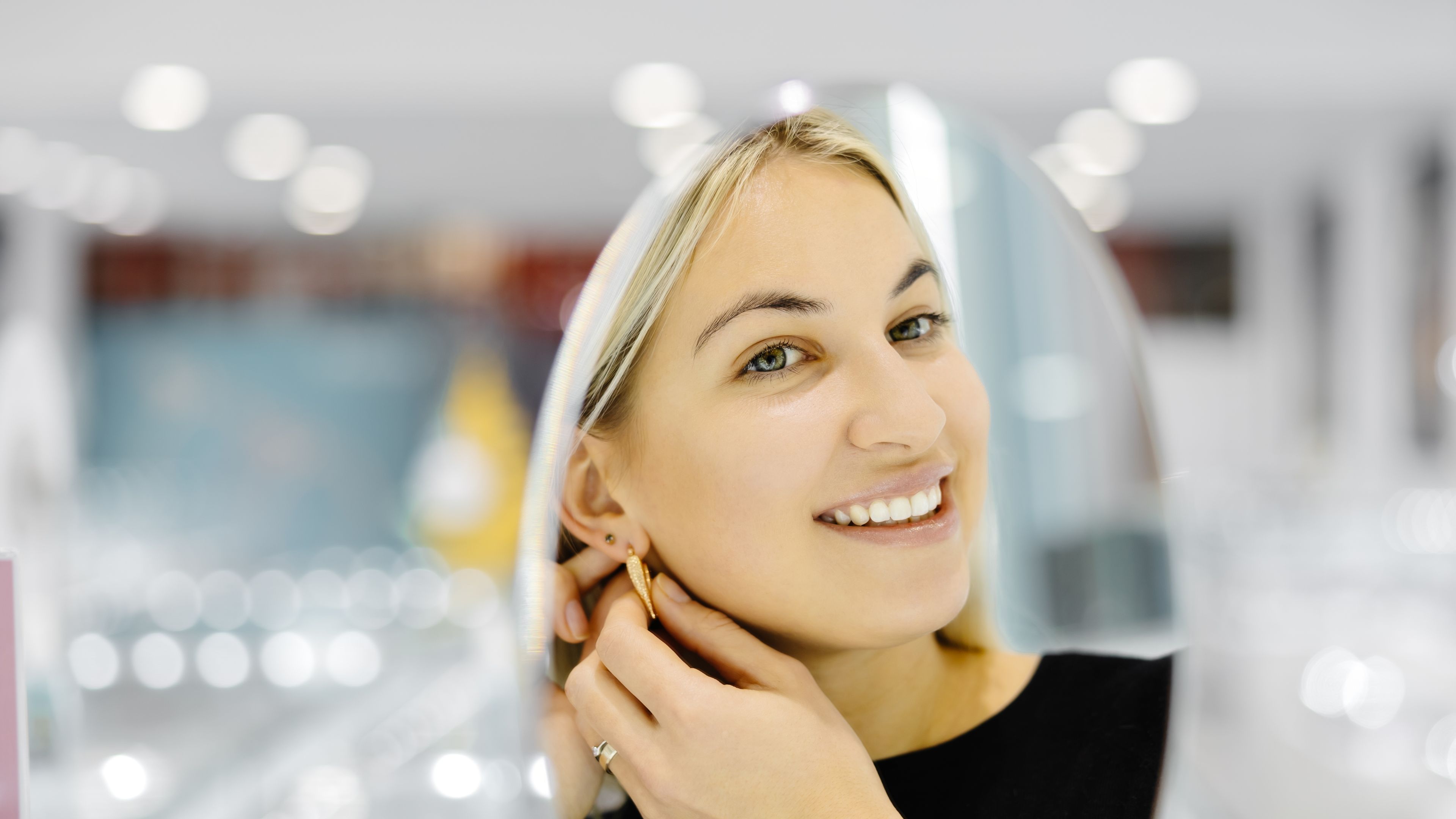 Woman trying earrings
